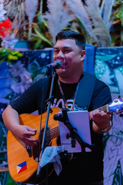 Ralph smiling during a live garden performance
